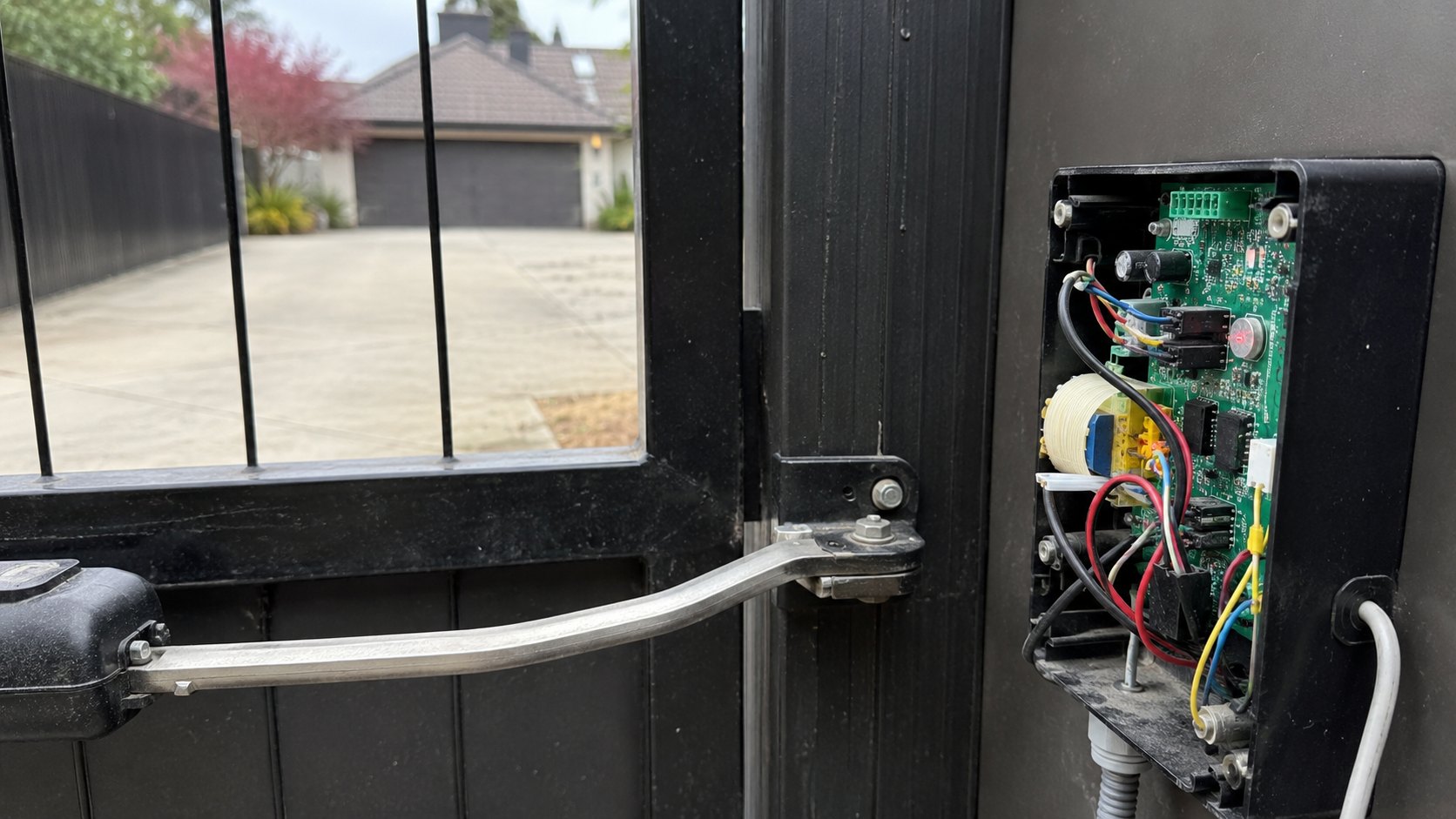 The operator arm and open control box of an automated driveway gate