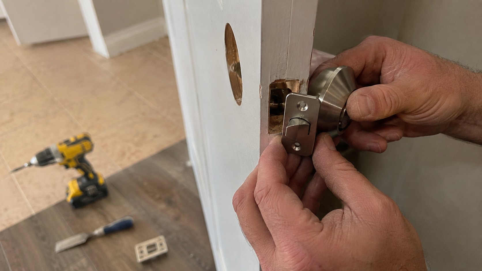 Fitting a new deadbolt into a freshly bored hole in a painted front door