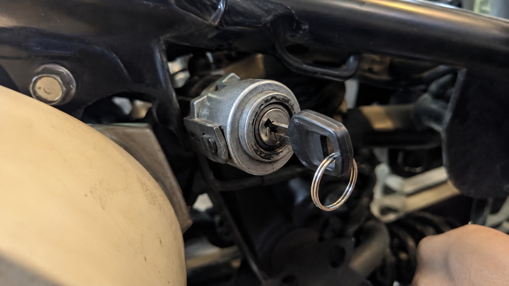 A motorcycle ignition barrel and a newly cut key