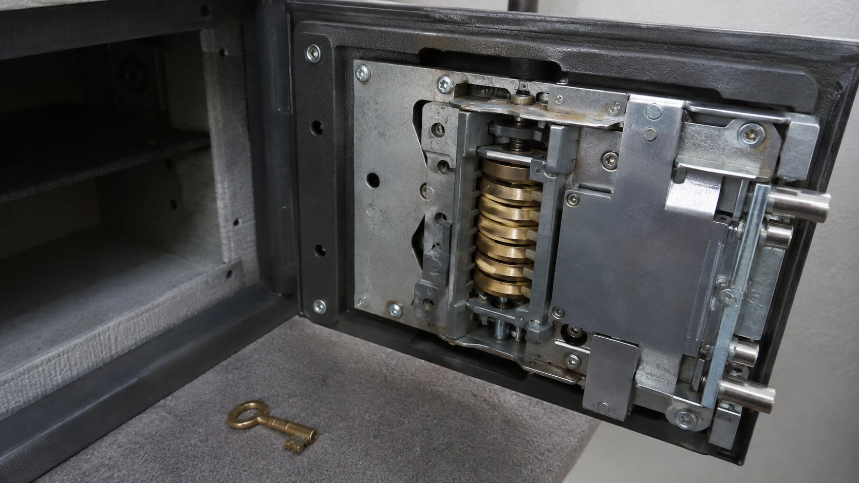 The back of a safe door showing the combination lock body and change key hole